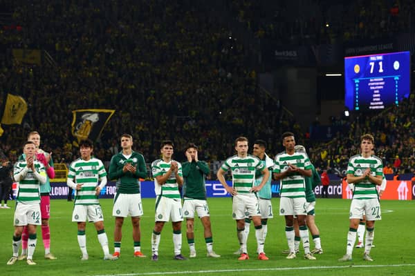 Dejected Celtic players acknowledge the travelling away support.