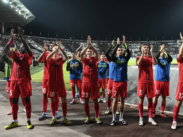 FCSB's players celebrate after defeating PAOK during their UEFA Europa League, league phase match at Toumba Stadium in Thessaloniki