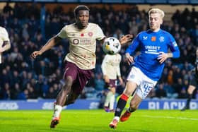 Rangers' Ross McCausland and Hearts' Daniel Oyegoke in action