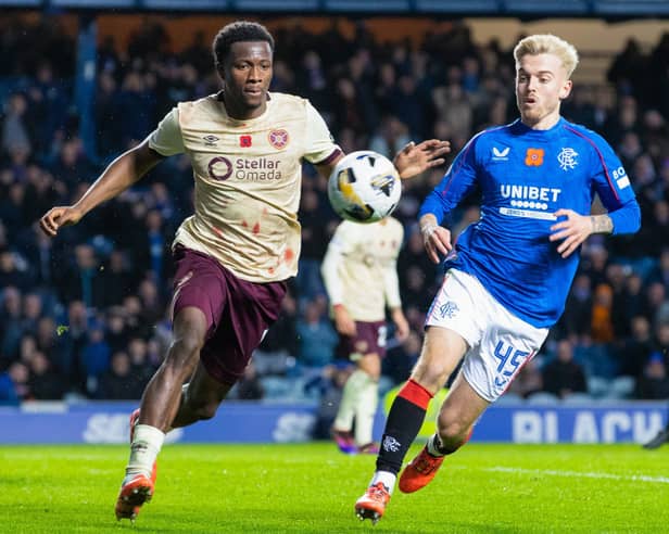 Rangers' Ross McCausland and Hearts' Daniel Oyegoke in action