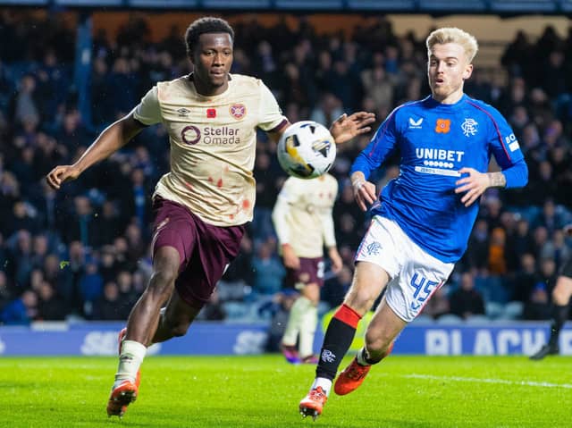 Rangers' Ross McCausland and Hearts' Daniel Oyegoke in action
