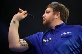 Cameron Menzies of Scotland throws during their first round match against Dave Chisnall of England
