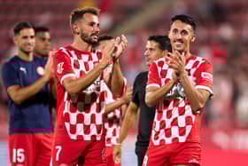Cristhian Stuani and Bojan Miovski of Girona FC applaud supporters