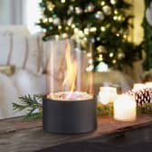 The fireplace can sit in any room, giving off heat and setting a festive mood