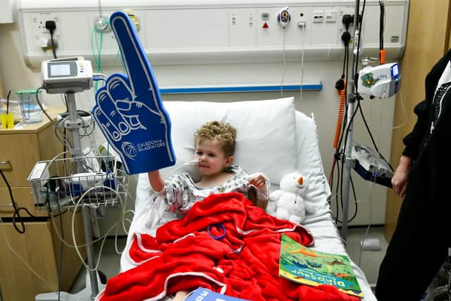 One child at the hospital pictured with a Gladiators foam finger, gifted by the club.