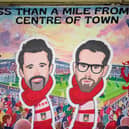 A banner of Wrexham owners Rob McElhenney and Ryan Reynolds