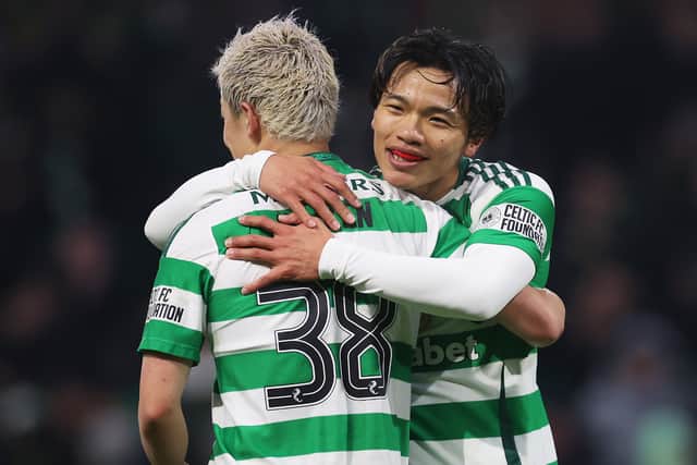 Reo Hatate of Celtic celebrates scoring his team's second goal with teammate Daizen Maeda vs Dundee United