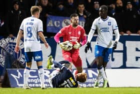 Simon Murray lies on the ground after clashing with Clinton Nsiala during Dundee's 1-1 draw with Rangers.