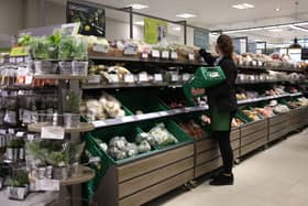 An employee stacks shelves at a Waitrose supermarket (Photo: HOLLIE ADAMS/AFP via Getty Images)