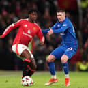 Rangers' Bailey Rice challenges for the ball against Man Utd's Kobbie Mainoo.