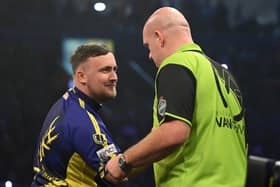 Luke Littler congratulates Michael van Gerwen on his victory during the opening night of the Premier League Darts season at The SSE Arena Belfast