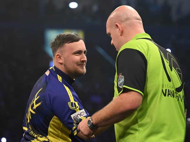 Luke Littler congratulates Michael van Gerwen on his victory during the opening night of the Premier League Darts season at The SSE Arena Belfast