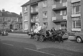 A rag and bone man heading along the street back in the day. 