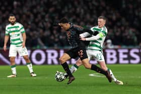 Jamal Musiala of Bayern Munich is challenged by Callum McGregor of Celtic 