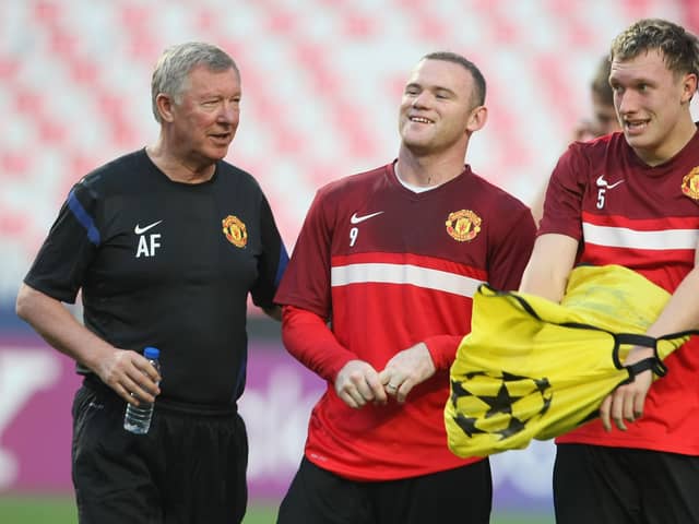 Sir Alex Ferguson (L), Wayne Rooney and Phil Jones of Manchester United in action during a first team training session ahead of the UEFA Champions League Group C match against Benfica at the Estadio da Luz on September 13, 2011 in Lisbon, Portugal.  