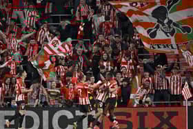 Athletic Bilbao forward Nico Williams celebrates with teammates and supporters after scoring his team's third goal during the UEFA Europa League last 16 second leg clash against AS Roma at the San Mames stadium