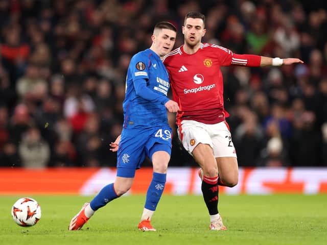 Bailey Rice of Rangers is put under pressure by Diogo Dalot of Manchester United in action at Old Trafford