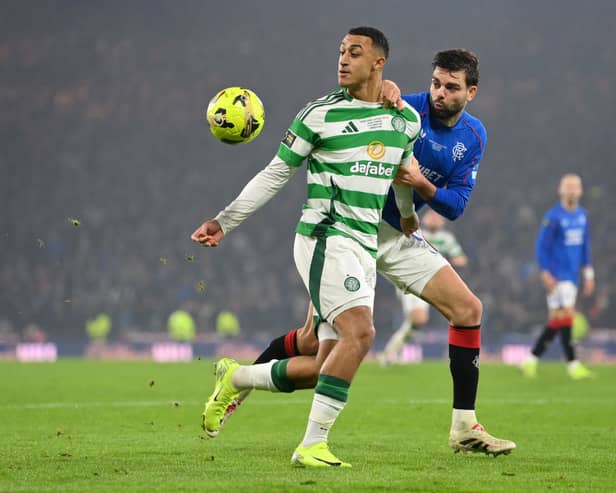 Adam Idah of Celtic and Robin Propper of Rangers FC compete for the ball 
