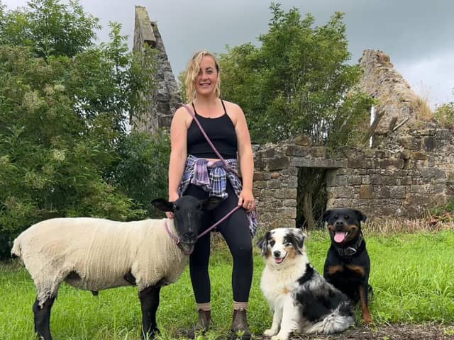 Robyn Swan moved out of her home to live rent-free in a container in rural Scotland, growing her own food and harvesting rainwater. She is pictured with her pet sheep and dogs. Photo: Robyn Swan / SWNS