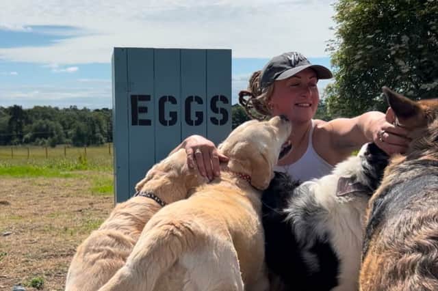 Robyn, who sold all her belongings to live off-grid in rural Scotland, with her dogs. Photo: Robyn Swan / SWNS