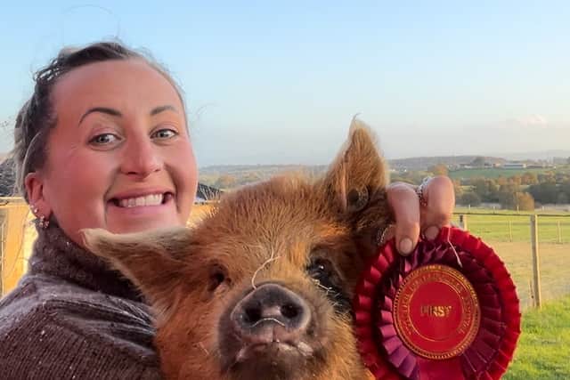 Robyn, who aims to live completely self-sufficiently in her container home in rural Scotland, with her pig. Photo: Robyn Swan / SWNS