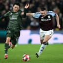 Aston Villa midfielder John McGinn battles for the ball with Celtic winger Yang Hyun-Jun during the Champions League clash at Villa Park