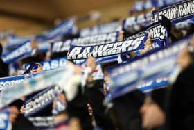 Rangers fans hold up scarves during a match