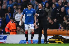 Barry Ferguson grabs the arm of Ianis Hagi to pass on instructions