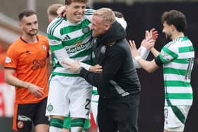 Arne Engels of Celtic celebrates with injured Kasper Schmeichel at Tannadice