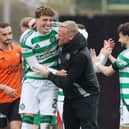Arne Engels of Celtic celebrates with injured Kasper Schmeichel at Tannadice