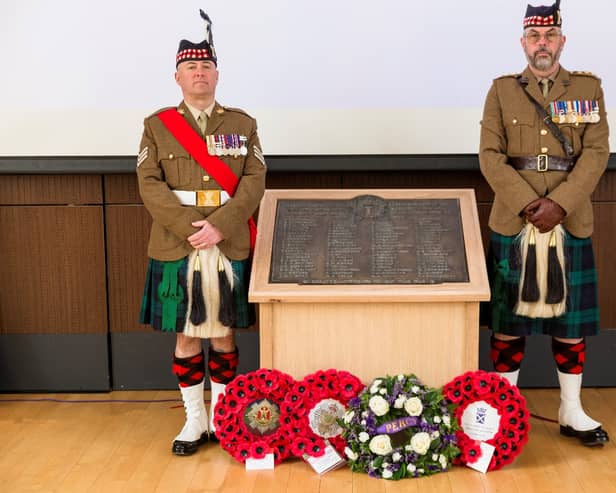 Sgt James Gould and  Captain William Jason Craig of 6 SCOTS present the WWI memorial plaque back into the local community