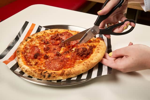 Cutting a pizza with sicissors made number eight on the list of worst pizza icks