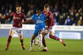 Kwame Poku of Peterborough United attempts to control the ball under pressure from Patrick Brough