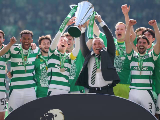 Callum McGregor and Celtic manager Brendan Rodgers lift the Scottish Premiership trophy