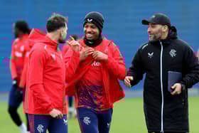 Issame Charai, assistant manager of Rangers, shares a joke with Nedim Bajrami and Hamza Igamane ahead of training