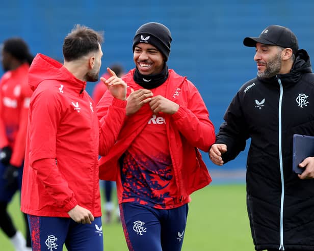Issame Charai, assistant manager of Rangers, shares a joke with Nedim Bajrami and Hamza Igamane ahead of training