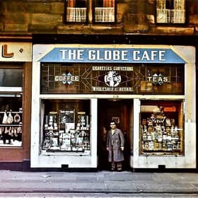 The Globe Cafe owner Dino Bigotti standing in the doorway of the premises at 205 Paisley Road West in the 1950s. 