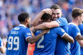 Rangers captain James Tavernier is congratulated by Danilo (L) and John Souttar as he scores to make it 1-0 against Motherwell