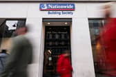 Members of the public walk past the Nationwide Building Society in London. Nationwide has pledged to keep all 696 of its branches, including Virgin Money locations, open until at least 2030 (Photo: Dan Kitwood/Getty Images)