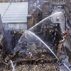 Firefighters have been continuing to damp down the building in central Glasgow that was gutted by a devastating fire at the weekend (Picture: John Devlin)