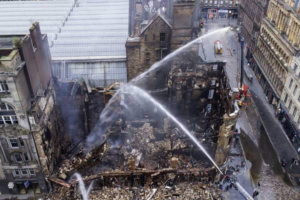 Firefighters have been continuing to damp down the building in central Glasgow that was gutted by a devastating fire at the weekend (Picture: John Devlin)