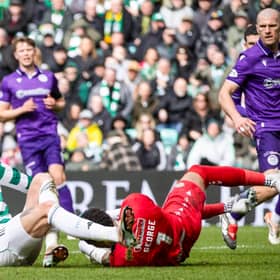 Celtic's Tomas Cvancara (L) collides with St Mirren goalkeeper Shamal George at Parkhead.
