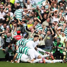 Daizen Maeda is mobbed by his Celtic teammates after a stunning overhead kick clinched a win over Rangers.