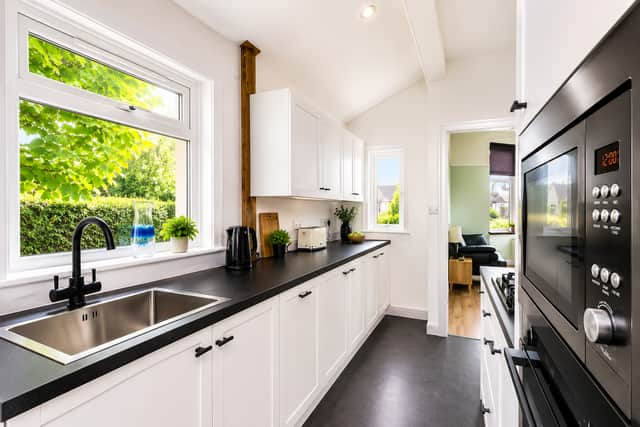 The modern fitted kitchen connects seamlessly with the additional family room for versatile living