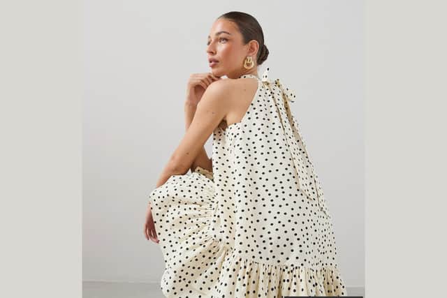 The Very Collection polka dot mini dress combines a timeless print with a playful tiered frill design.