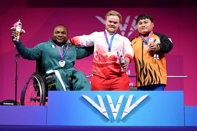 Gold medalist Mark Swan of Team England (C), Silver medalist Roland Ezuruike of Team Nigeria (L) and Bronze medalist Bonnie Bunyau Gustin of Team Malaysia (R) pose for a photo during the medal ceremony for Men's Para Powerlifting Lightweight Group A