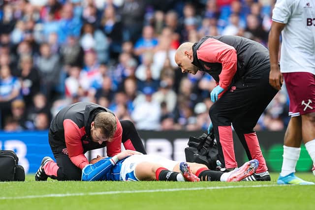 Thelo Aasgaard of Rangers receives treatment for an injury during the pre-season friendly match between Rangers and West Ham at Ibrox