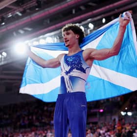 Reuben Ward of Team Scotland poses for a photo after winning gold in the Men's All-Around Final