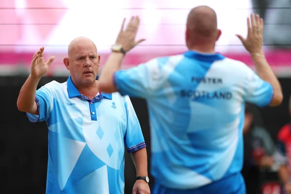 Alex Marshall of Team Scotland celebrates with teammate Paul Foster during the Men's Lawn Bowls Pairs at the 2022 Commonwealth Games