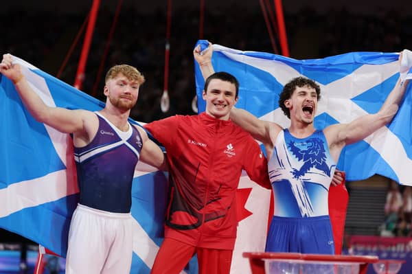 Gold medalist Jordan Carroll of Team Canada (C), Silver medalist Reuben Ward of Team Scotland (R) and Bronze medalist Cameron Lynn of Team Scotland (L) pose for a photo after the Men's Pommel Horse Final